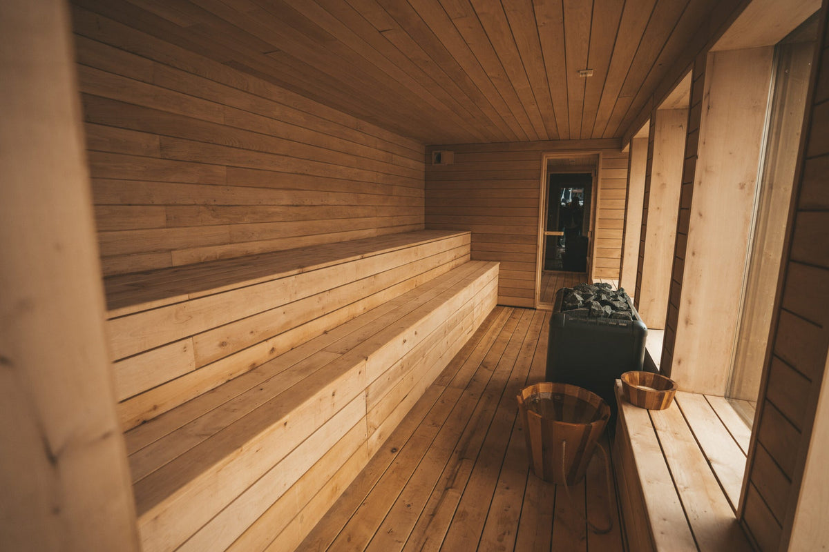 Premium cedar home sauna interior with tiered benches and heater