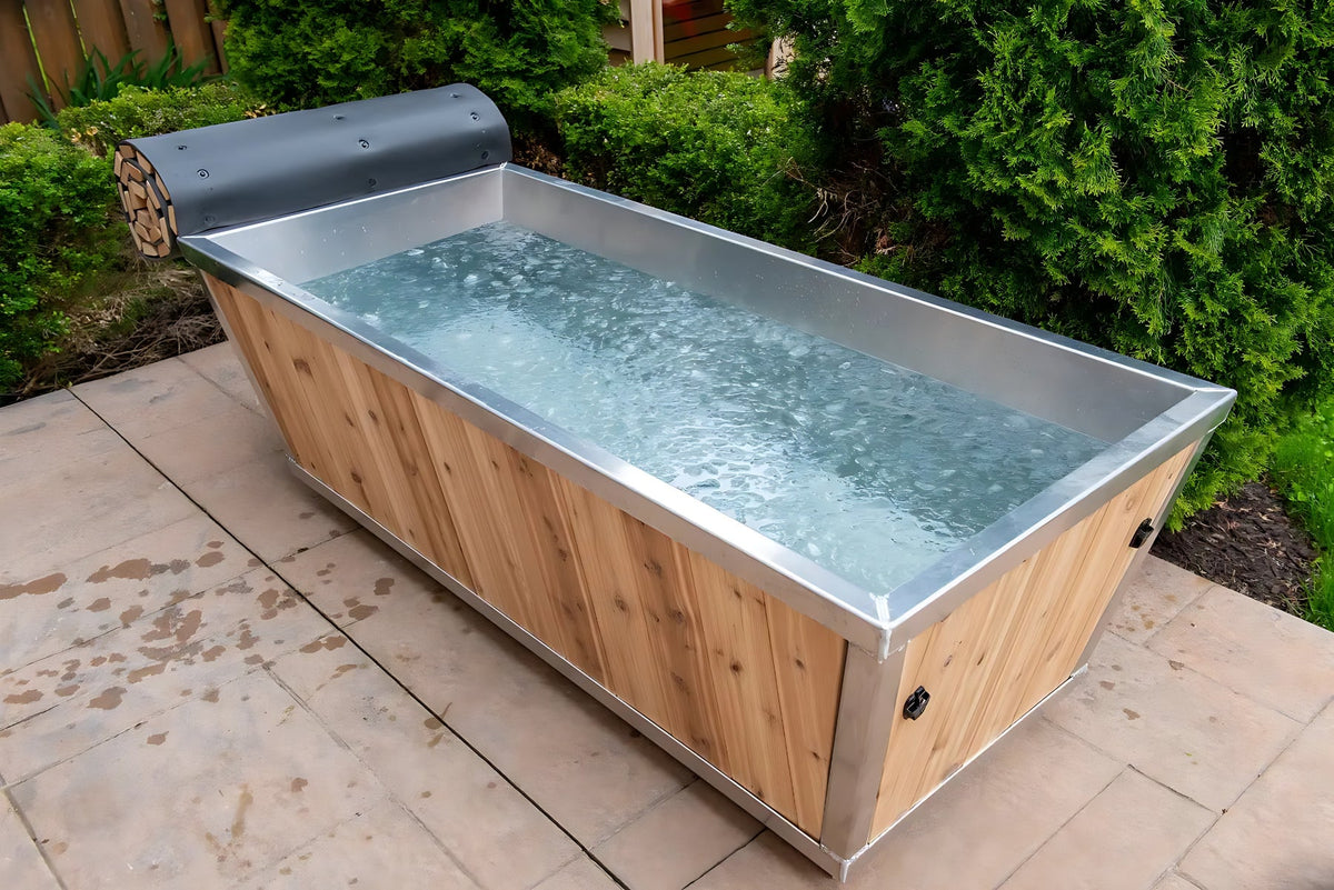 Cedar cold plunge tub filled with water on a stone patio