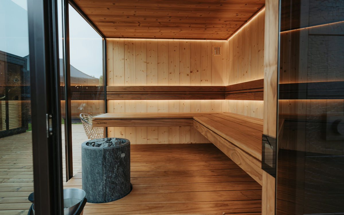 Interior of a modern wood-lined home sauna with warm ambient lighting
